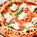 Wood-fired pizza with fresh mozzarella, basil, and tomato sauce in traditional Neapolitan style