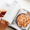 BBQ recipe card with grilled shrimp skewers on white plate and croissant on marble surface