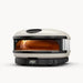 Compact black outdoor pizza oven with amber-glowing interior, stainless steel top, and stone base