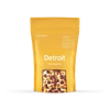 Yellow kraft paper bag with wood pellets visible through window, Detroit flavor BBQ smoking pellets