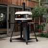 Gozney Dome pizza oven on black metal cart stand with wheels in outdoor patio setting