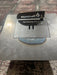 Black metal grill firebox with flame logo and text, mounted on stainless steel base plate