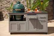 Two-piece coastal gray outdoor kitchen island with Big Green Egg base, stainless countertop, and cabinet storage